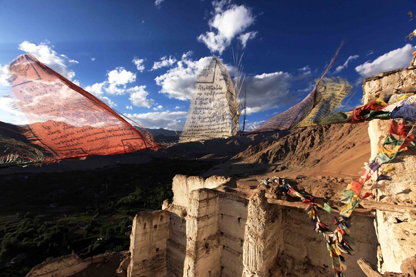 Prayer flags dancing in the wind above the ruined ramparts of Sankar Gompa, Ladakh, northwest India  © David Pickford