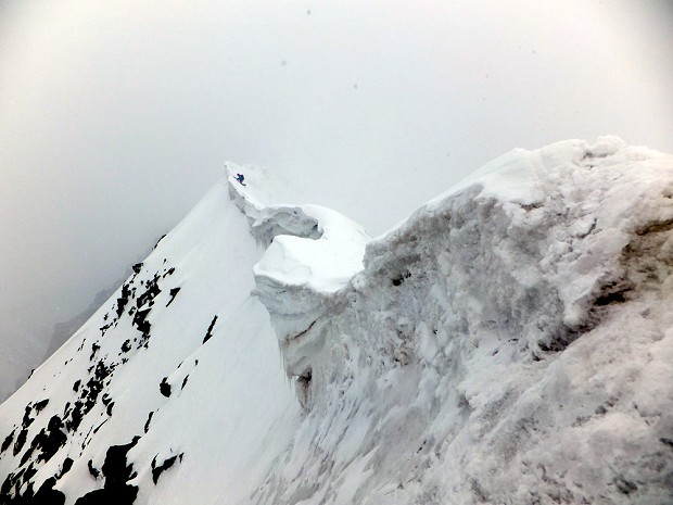 Ross negotiates the difficult cornices on the summit ridge of Pik Currahee (5025m) - Photo by Clay Conlon  © George Cave