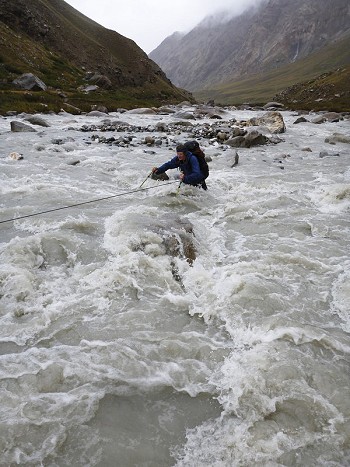 HarryB struggles to cross the fast flowing Djangart river on the return to basecamp - Photo by George Cave  © George Cave