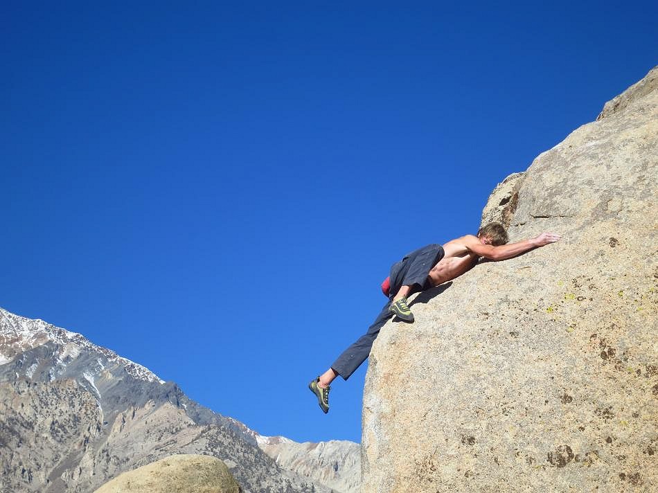 Howard Lawledge bellyflopping on the top-out of Pope's Prow, V6, Buttermilks, California  © Tom Ripley