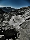 A lone figure trudging through the snow in July high on the GR20, Corsica