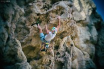 Climber on the crux of Vipera, Hatta, Oman