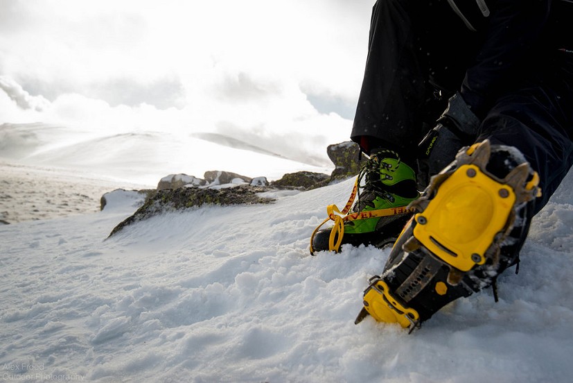 My friend putting crampons on for the first time.   © AlexFrood
