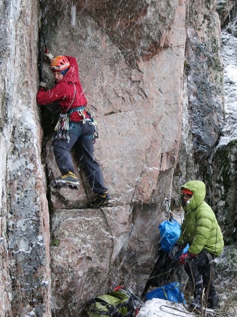 Henkka borrows the Fjörm while belaying me in a soggy blizzard  © Toby Archer