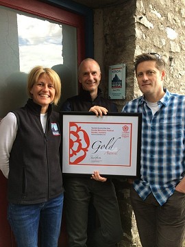 Claire Wickham (Event Manager), Clive Allen (Director), Steve Scott (Director) with the Award  © Kendal Mountain Festival
