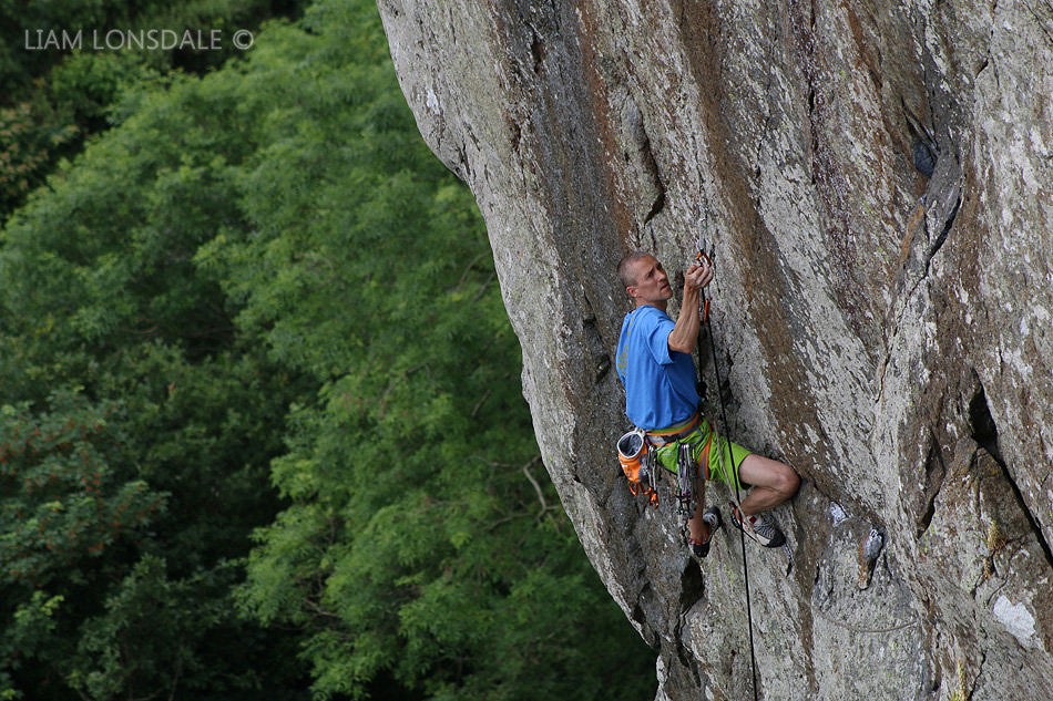 Steve McClure sorting the fiddly lower runners on his re-enactment of his onsight of Strawberries, E7 6b, Tremadog  © Liam Lonsdale