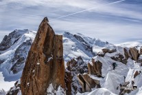 Climber on Cosmique Arete with beautiful vistas of the Mt. Blanc range behind