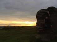 Kyle climbing Prow Right (V0- 4c) at sunset on Victory boulder, Birchen Edge.