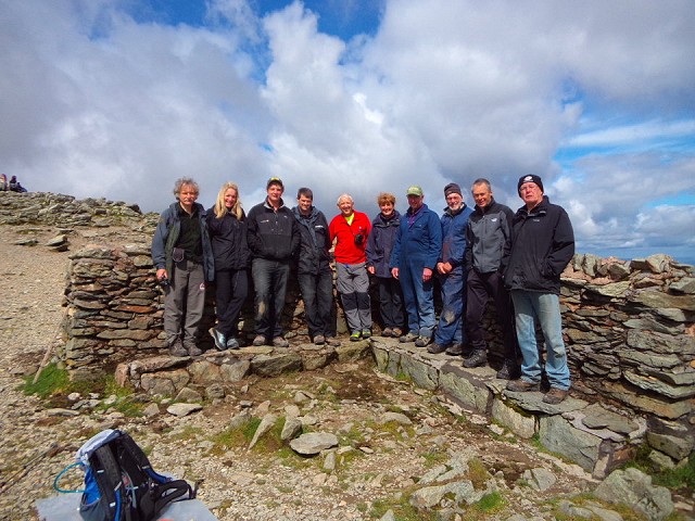 The repair team at the newly tarted up summit shelter  © Lake District National Park