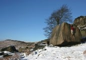 Lone boulderer latching the top of Deliverance at a deserted Stanage Plantation, Boxing Day 2004