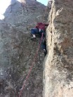 Andrew reaching the top of Right Angle on his first go at climbing.