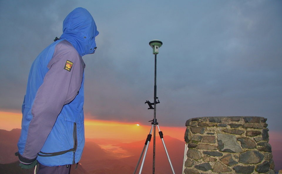 Graham watching the sunrise over Moel Siabod from the summit of Snowdon  © G&J surveys