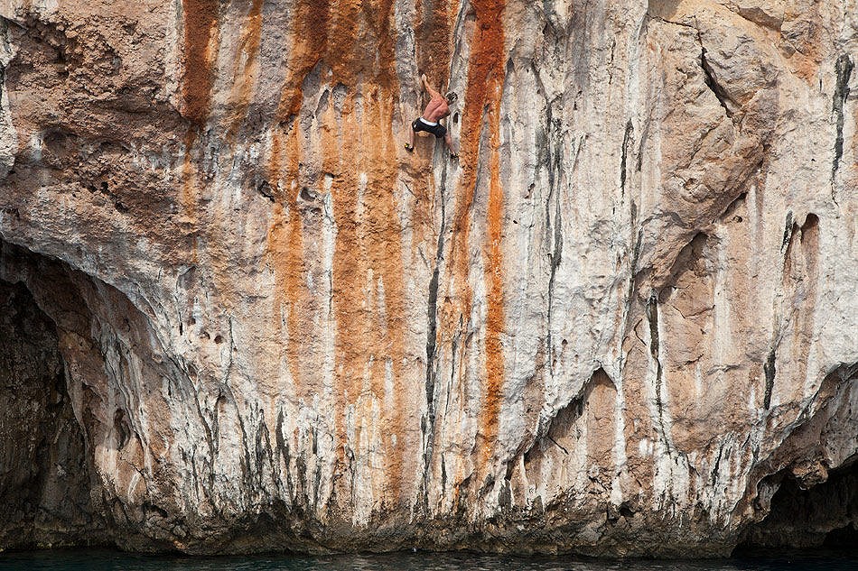 Loic Gaidioz attempting an unclimbed line above the sea, the initial tufa blanked out to nothingness  © Jack Geldard - UKC