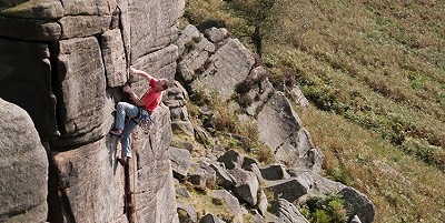 Left Unconquerable at Stanage. Andy Birtwistle climbing.  © Chris Craggs
