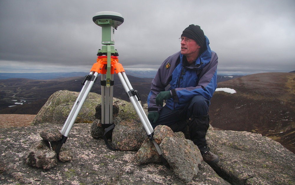 Graham beside the Leica GS15 on the summit tor of Meall Gaineimh  © Myrddyn Phillips