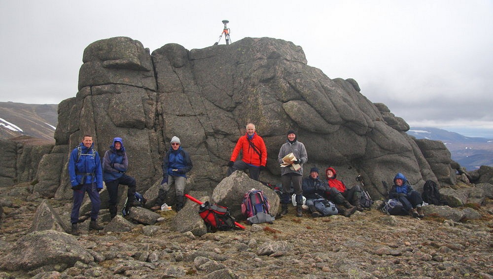 The Leica GS15 on the summit tor of Meall Gaineimh with some of the team sheltering below   © Myrddyn Phillips