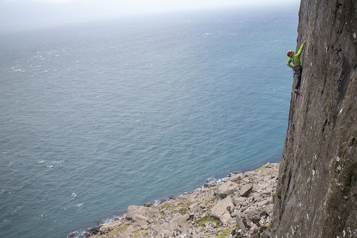 The author plugging in innumerable camming devices on Jolly Roger at Fair Head  © Rob Greenwood - UKClimbing