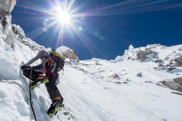 Andy climbing the upper slopes of the NW Face under the powerful Karakorum Sun.  © The North Face/Jon Griffith