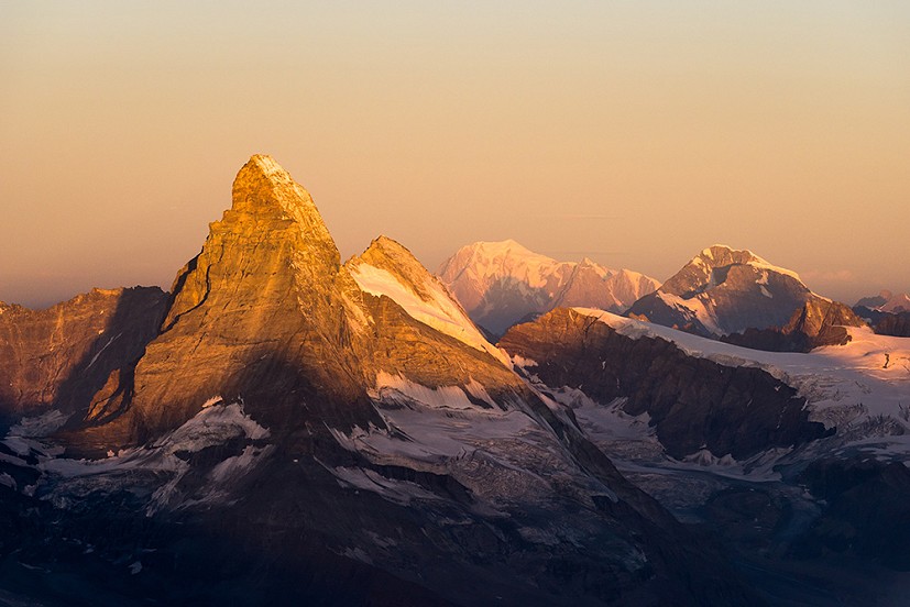 Matterhorn, Mont Blanc and Grand Combin at sunrise from the Rimpfischhorn  © Ben Tibbetts
