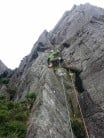 John Roberts trying to avoid the muddy ledge (stick to the rock) on Zip Groove, Carreg Mianog