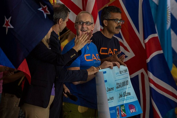 John presents a cheque to a Mexican cancer research organisation  © John Ellison