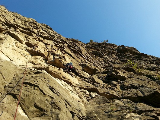 Colin traversing under the overhangs on the first pitch  © Si Carter