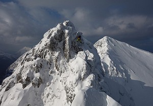 Andrew Marshall climbing past the pinnacles on the Aonach Eagach  © wee jamie