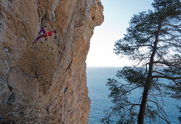 Natalie Berry making a smooth ascent of American (7b) in the atmospheric cave of Sector Oasis at Cala Llamp.  © Alan James