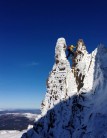An unknown climber makes the step on Fingers Ridge in beautiful conditions