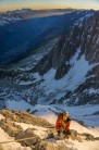 Harry Lewis about to top out the Frendo Spur in Chamonix, as the sun rises behind him.