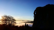 Beautiful cloud inversion at The Plantation, Stanage. Image takes of someone climbing the pebble boulder