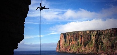 Becky doing her aerial abseiling routine on the Old Man of Hoy!  © Jon Garside