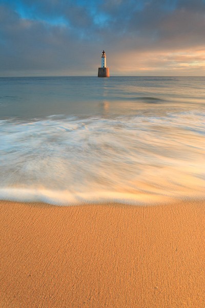 Sunrise on the beach at Rattray head lighthouse  © Chazsands