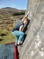 Emma on the technical lower moves of 'Slot Entry' at Burbage South Valley Boulders