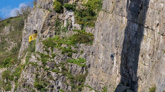 A climber making the most of the spring sun on Suspension Bridge Buttress.  © climberinspace
