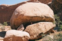 DaveO being devoured by a boulder in Arches NP, Moab