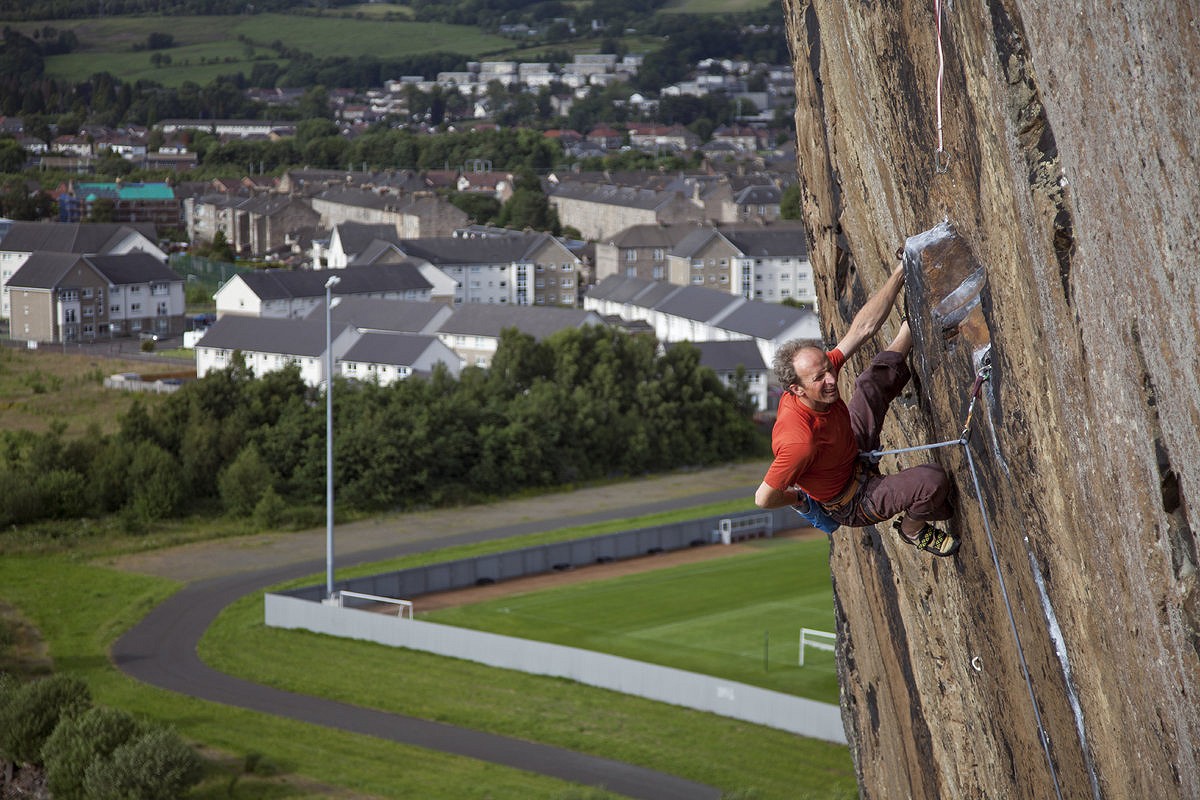 Iain Small chalking up against the backdrop of the new housing estates  © Martin McKenna