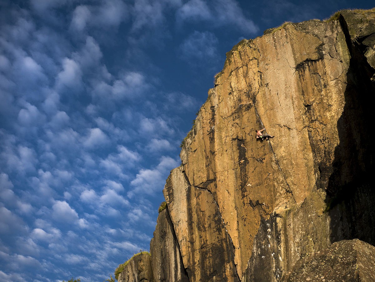 Niall chalking up on Requiem, surrounded by a surreal sky  © Martin McKenna