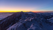 Winter sun sets above the summit of Vrtača peak, Karawanken range, Slovenia