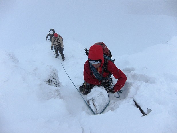 Guide short-roping clients on Beinn a' Chaorainn - not a skill you should just try to DIY!  © Dan Bailey