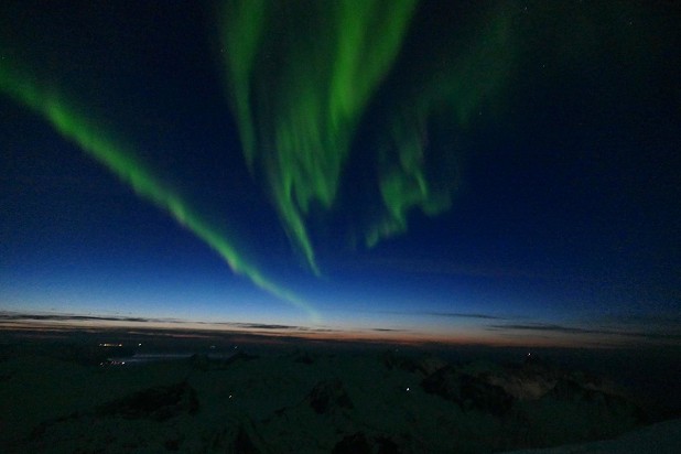 The Aurora Borealis dances above after a hard day's climbing.  © Greg Boswell