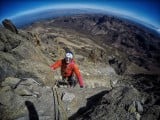 Jon Guptason nearing the top of the classic north face route on Mt Kenya<br>© mountaindavet