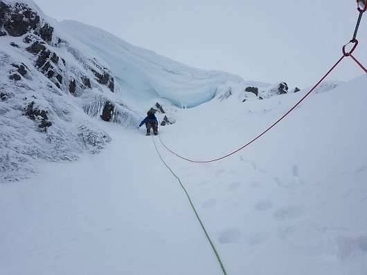Sumit pitch under cornice; Chris Reid searching for a way over.  © Buncie