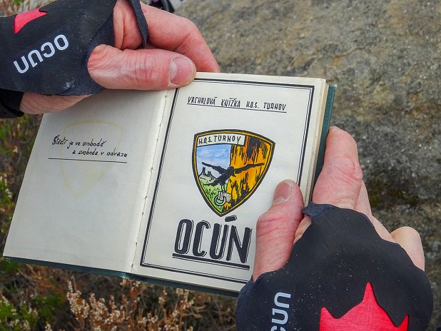 Ocun crack gloves holding the Ocun logbook on top of the Ocun tower!  © Theo Moore
