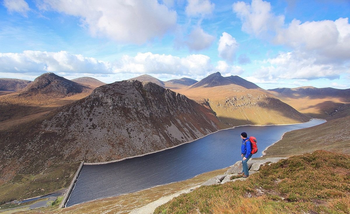Ben Crom and other summits rising behind Ben Crom Reservoir, seen from slabs on the slopes of Slieve Binnian  © Adrian Hendroff