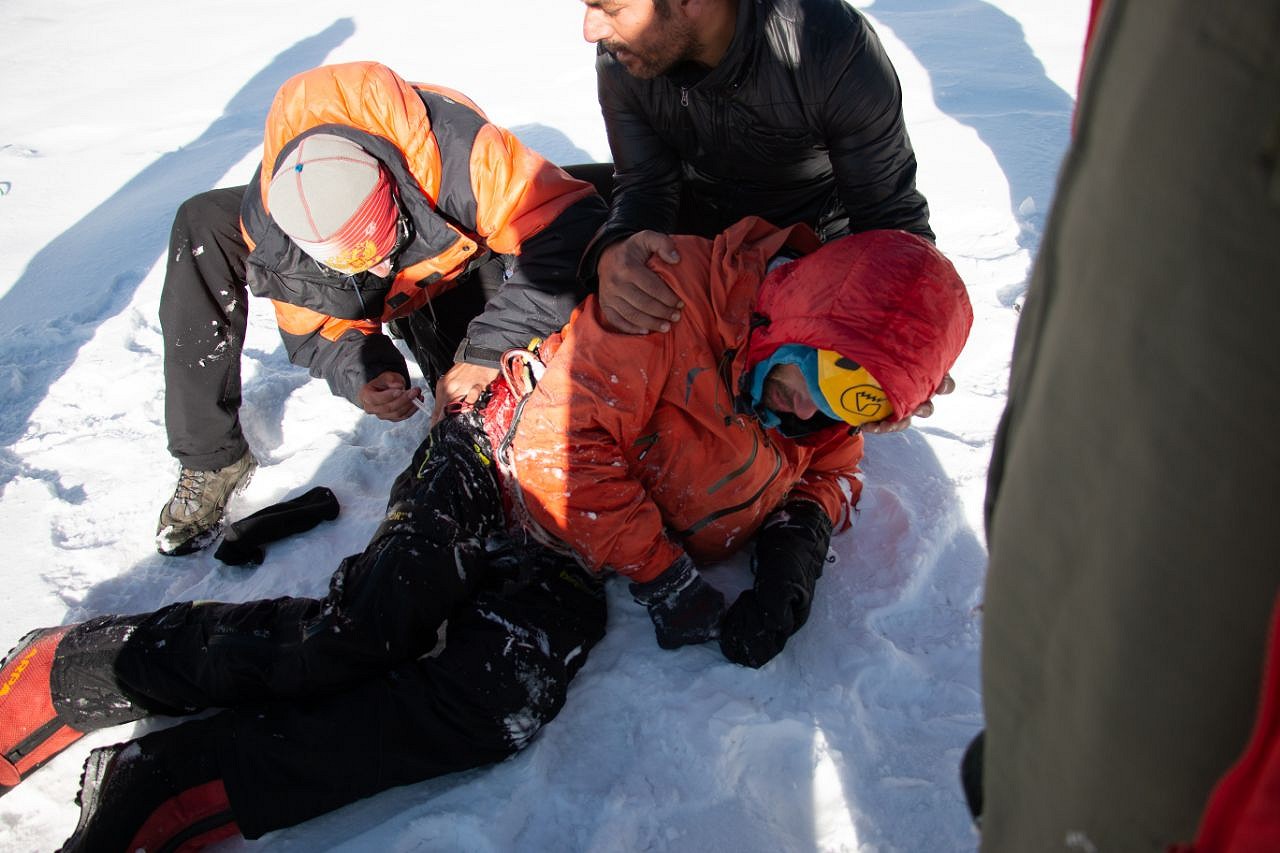 Alex Gukov is detached from the helicopter sling at Base Camp.  © UKC News