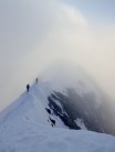 Traversing the final snow arete to the summit at 8am on a classic traverse of the Weissmies