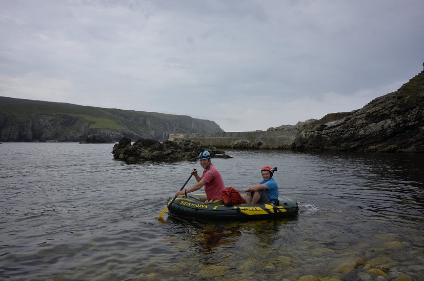 Iain cheerily paddling out into the North Atlantic in a kiddies dingy with a client.  © Martin Kocsis