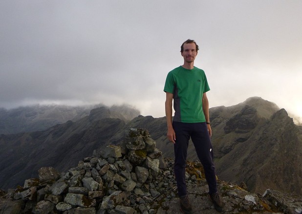 72 days after he started, Oli on the summit of Sgurr nan Gillean with the Cuillin Ridge behind him.  © Josh Wyatt