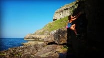 Naomi bouldering at pigeons cave on the great orme.  Llandudno